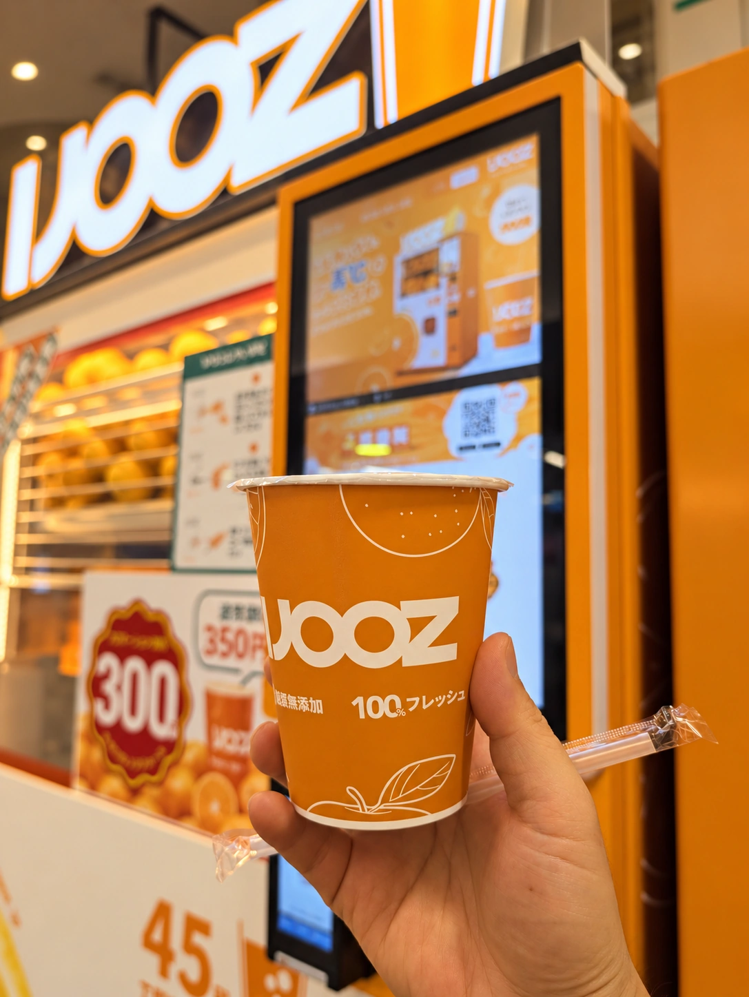 町田のIJOOZ店頭で手に持ったオレンジジュースの紙カップ